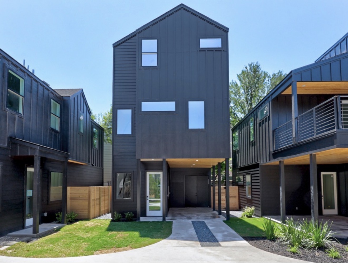 Close architectural view of the warm wood soffit and shadowed entrance